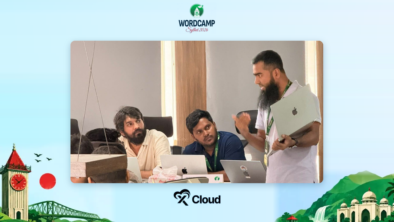 Contributors working together around a laptop table during Contributor Day at WordCamp Sylhet 2026